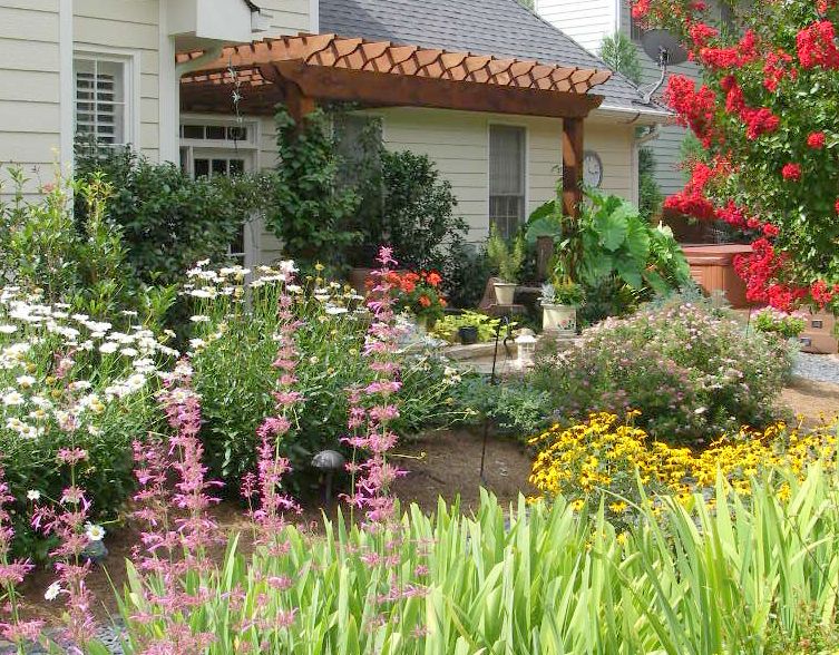 Arbor over patio perennial garden